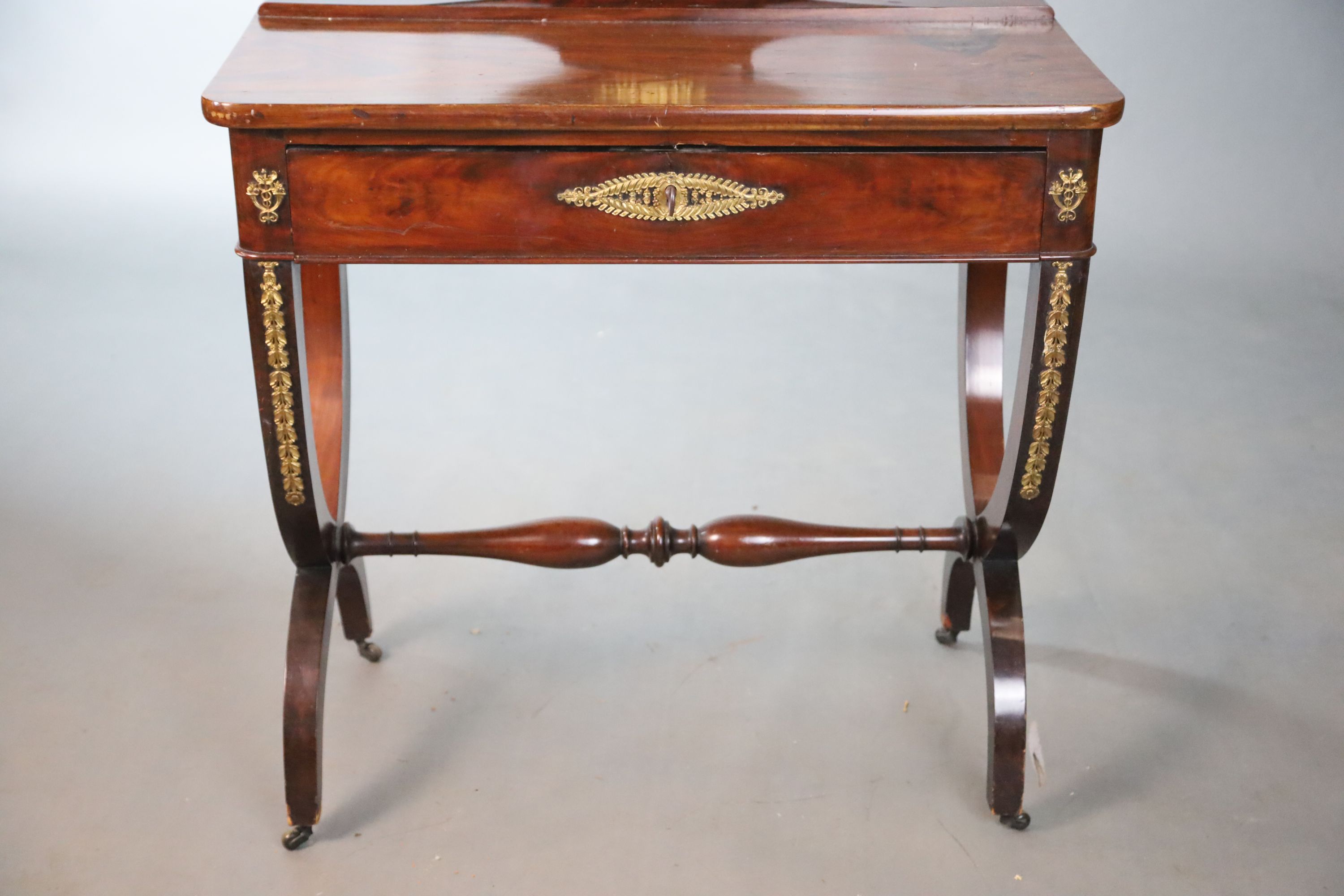 A Restauration gilt-bronze mounted mahogany dressing table, retailers stamp Edwards & Roberts, W.81.5cm D.42cm H.140cm